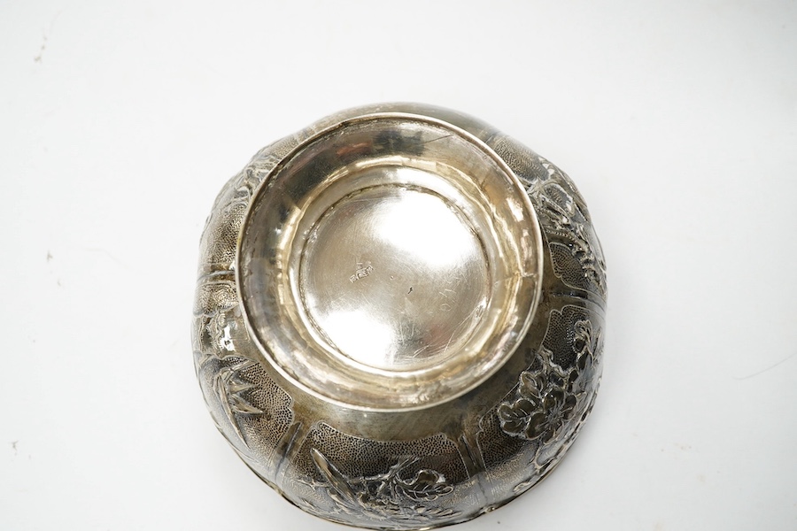 A late 19th/early 20th century Chinese white metal pedestal bowl, decorated with birds and foliage, diameter 15.2cm, 9.5oz. Condition - fair to good.